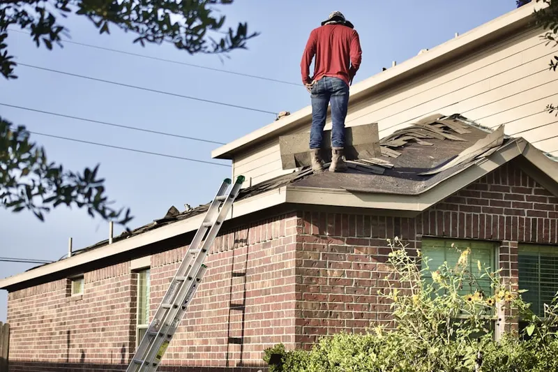Professional roofer working on a residential roof in Ronkonkoma